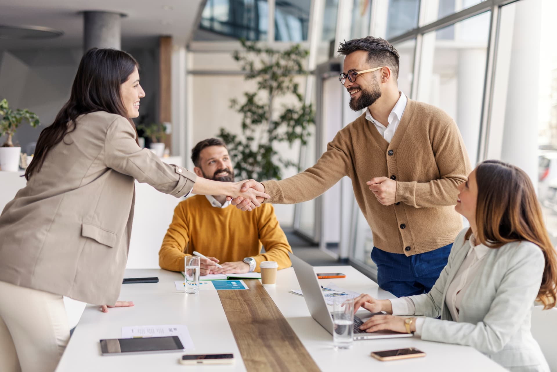 Professionals welcoming a new colleague into a team