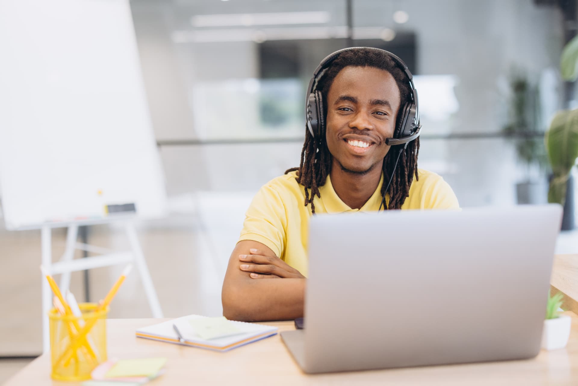 A remote professional working at a laptop with a headset
